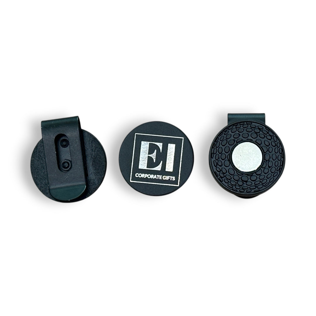 Engraved golf marker hat clip with magnetic design displayed outdoors on a golf course. A personalized promotional gift for golfers, ideal for tournaments, business giveaways, and corporate branding. Durable, lightweight, and custom engraved with your company logo.