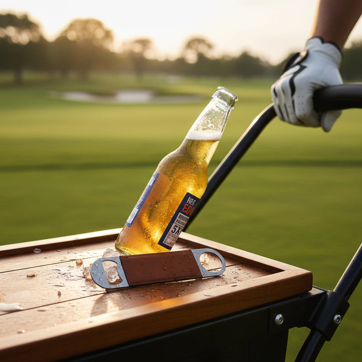 Leather golf bottle opener personalized with laser engraving, featuring a stainless steel opener and stitched leather strap. Available in black, gray, caramel, dark brown, and sand. Ideal for golf tournaments, corporate gifts, promotional branding, fundraisers, groomsmen gifts, and custom logo merchandise.